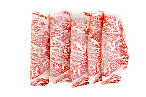 Isolated Premium Rare Slices Wagyu A5 beef with high-marbled texture on square wooden plate served for Sukiyaki and Shabu
