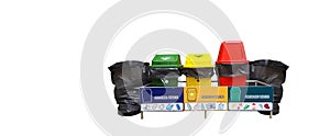 Isolated recycle bins including blue yellow red and black plastic bags at the both ends