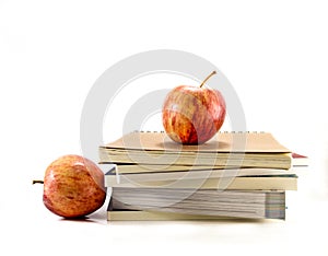 Isolated red apples with the books