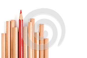 Isolated red colored pencil stand out of other brown pencils