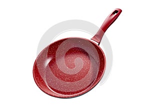 Isolated red kitchen frying pan tilted