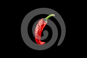 Isolated red pepper. Red hot chili paprika or spicy chile cayenne pepper isolated on black background. Ingredient for