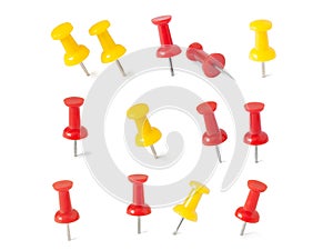 Isolated red and yellow push pins in white background photo