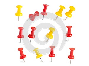 Isolated red and yellow push pins in white background