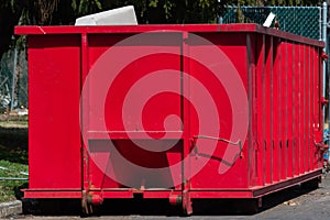 Isolated rugged red industrial dumpster garbage outdoor