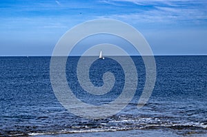 Isolated sailboat in the sea