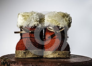 Isolated Santa`s red boots on wooden stool