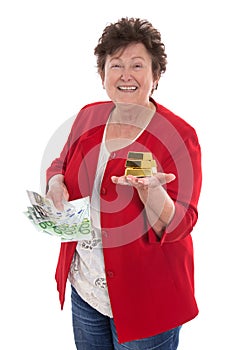 Isolated senior woman with money and gold: concept for pension a