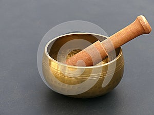 Isolated Shiny Brass Singing Bowl with Wooden Mallet