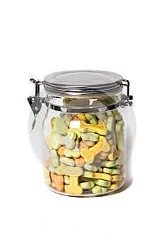 An isolated shot of a glass buket full of dog treats.