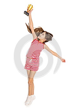 Isolated shot of happy active girl reaching high for trophy cup