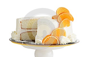 Isolated sliced vanilla cake with orange slices