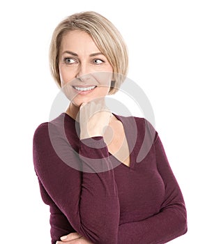 Isolated smiling middle aged woman in fall clothes looking sideways.