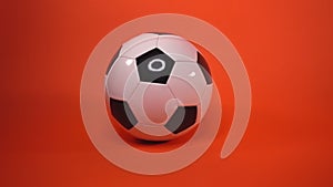 isolated soccer ball is spinning on red background. leather black and white soccer ball. Sports competition. Football