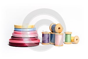 Isolated spools of colored threads with ribbon