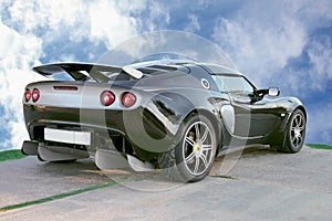 Isolated sport black car on blue sky background