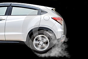 Isolated sport car wheel with drifting and smoking on a black b