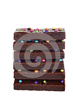 Isolated stack chocolate fudge brownies with candy pieces