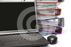 Isolated stack of folders with laptop computer