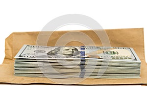 Isolated stack of hundred dollar bills on top of envelope