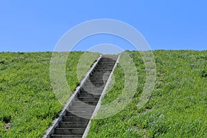 Isolated stairs, green grass, blue sky