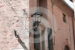 Isolated street lantern on a brick wall of an old house Pesaro, Italy
