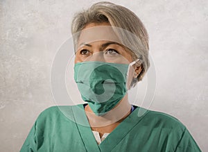 Isolated studio background portrait of mature attractive and confident medicine doctor woman or hospital nurse in medical gown and