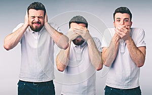 Isolated studio shot of a Caucasian woman in the See No Evil, Hear No Evil, Speak No Evil poses