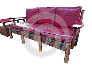 Isolated Thomas Molesworth furniture, western couch & table, has wood carving & red leather.