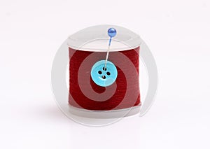 Isolated thread spool with pin on white background
