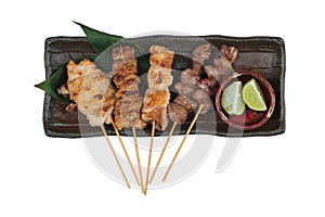 Isolated top view of Yakitori Japanese-Style Grilled Chicken Skewers with chicken and internal organ served with sliced lime.