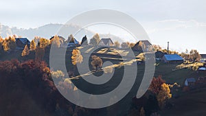 Isolated traditional Romanian houses built somewhere in a valley in Transylvania