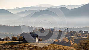 Isolated traditional Romanian houses built somewhere in a valley in Transylvania