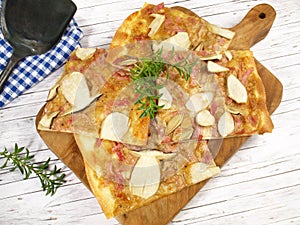 Isolated Traditional Tarte Flambee with Creme Fraiche, Mushrooms, Onion and Bacon