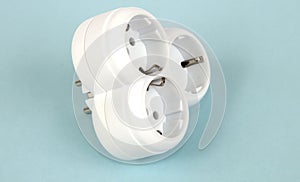 Isolated triple plug adapter on white background.