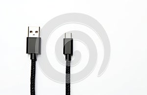 Isolated USB type A and type C cable on white. Black cord with connector for smartphone, computer. Universal standard connection, photo