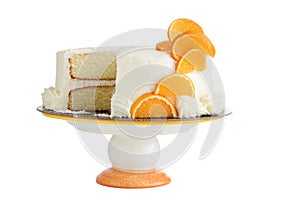 Isolated vanilla cake with orange slices on cake stand