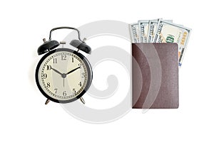 Isolated vintage alarm clock and cash money with passport on white background