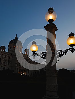 Isolated, vintage street lamp in front of the Natural Museum in Vienna, Austria at sunset
