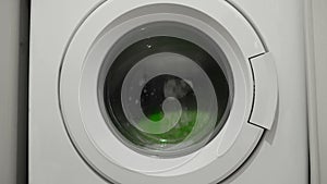 Isolated washing machine working on cleaning family clothes,electicity power wastage