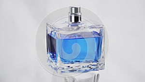 Isolated on white with 360 degrees in rotation of a men blue perfume. Cologne. Bottle spray