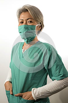 Isolated white background portrait of mature attractive and confident medicine doctor woman or hospital nurse in medical gown and