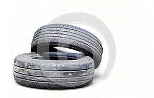 Isolated on a white background two black old car tires with copy space. Reuse of worn out rubber tires. Disposal of used