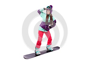 Pretty young woman in purple ski suit rides black snowboard