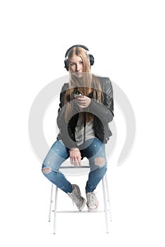 Isolated on white cute teenager girl portrait in wired headphones