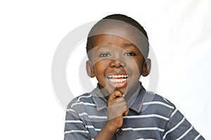 Portrait of African black boy child smiling with toothy smile isolated on white photo