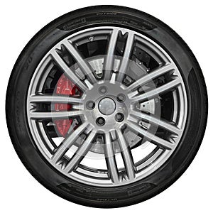 Isolated on white sport car wheel with metallic spoke rim, shine black tire, red disk brake. New clean car wheel disign element
