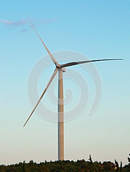 Isolated wind turbine at the top of a hill