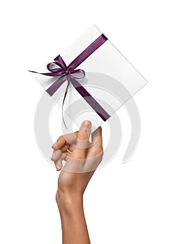 Isolated Woman Hands holding Holiday Present White Box with Purple Ribbon on a White Background