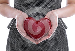 Isolated woman holding a red heart in her hands.